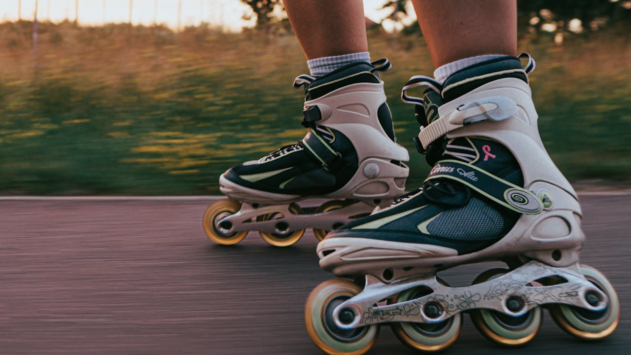 Dynamic close-up of rollerblades in motion on an outdoor path, capturing the essence of speed and movement.