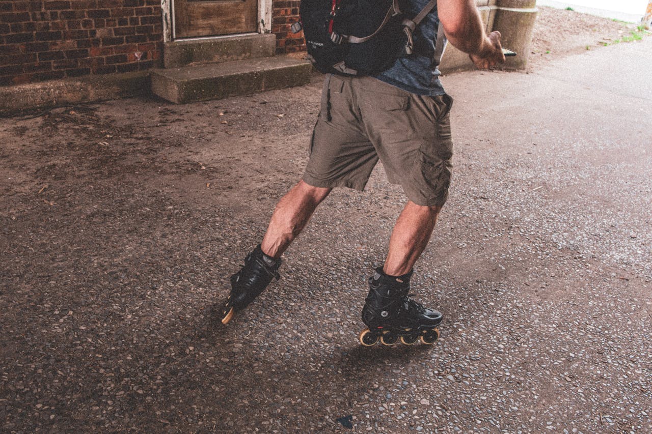 A man actively rollerblading on a rough urban surface, showcasing dynamic movement and outdoor lifestyle.